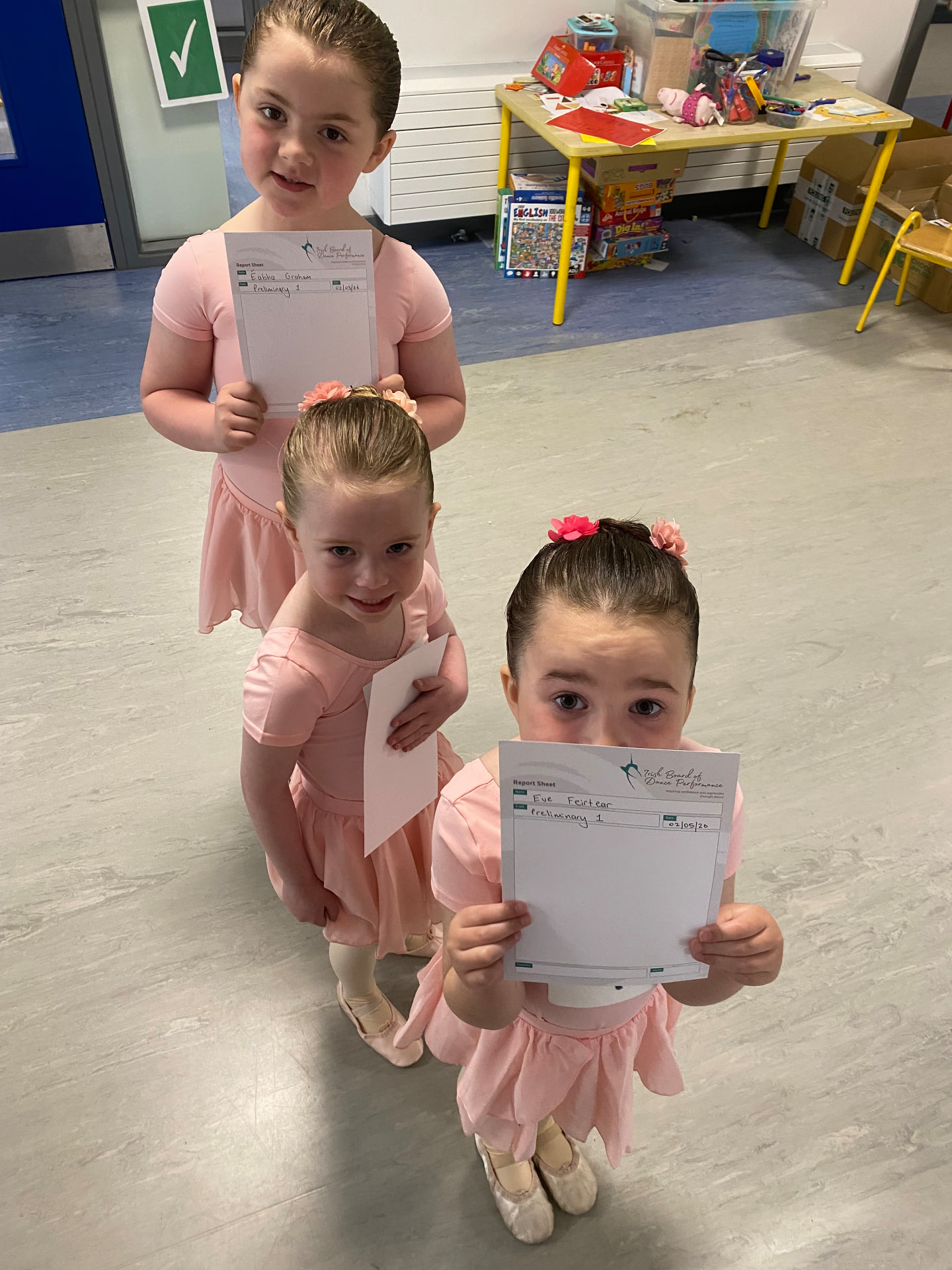 Students holding their examination report sheets