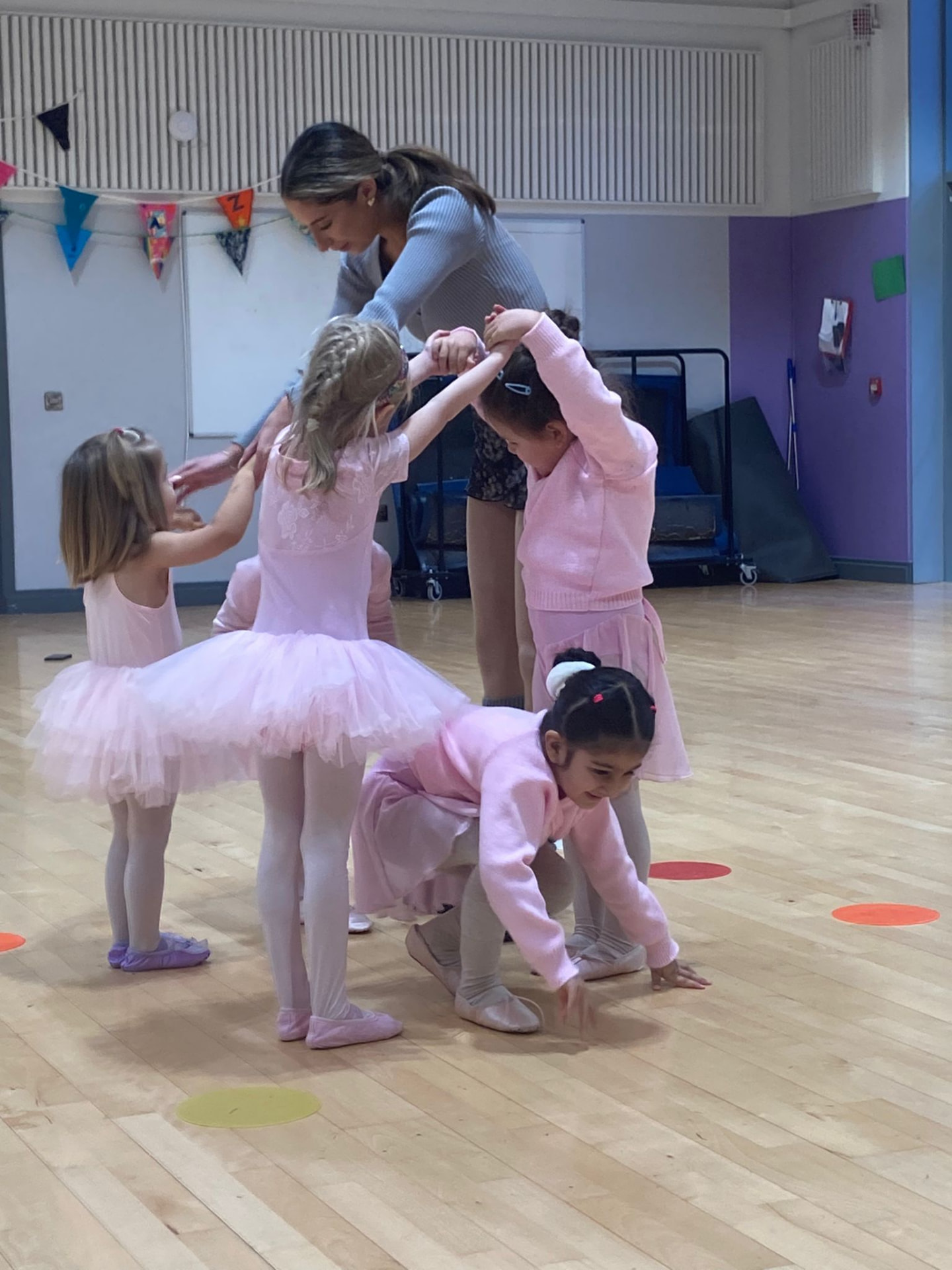 Dancers and teacher forming a circle in the studio